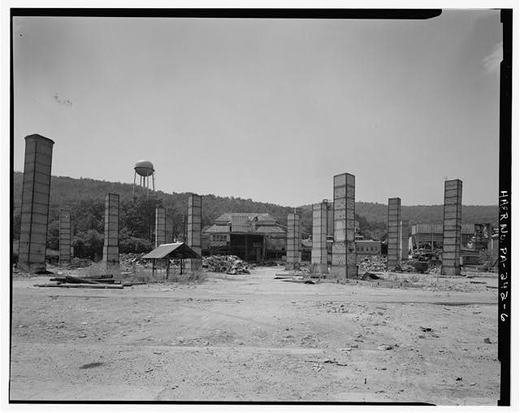 General view looking west from eastern edge of complex. Kilns have been demolished but kiln stacks still stand.