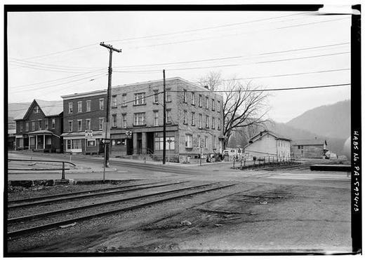 View showing corner of Jefferson street and Pennsylvania avenue looking west, showing conrail freight station at far right, hotel in center and stores - town of Mount Union